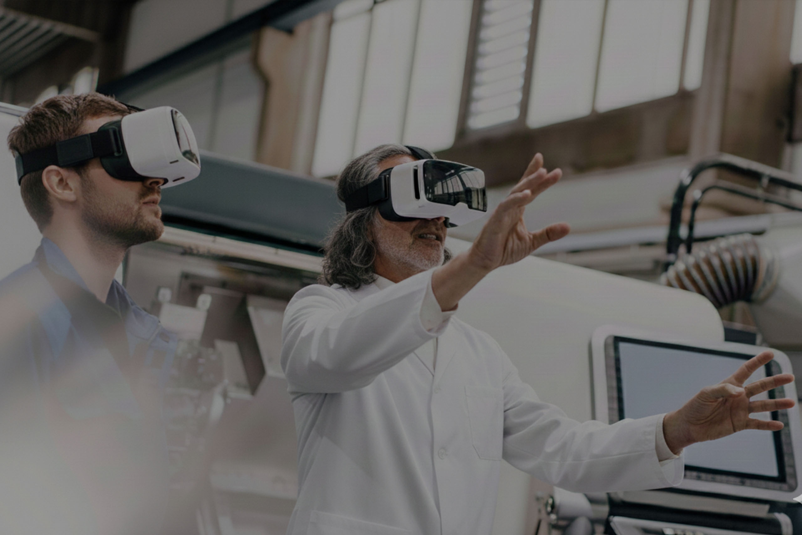 Researchers with VR headsets in a machine hall